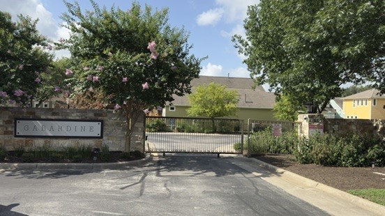 12212 Tawny Farms Road, Unit 142 Austin, TX 78748 - Photo 21 of 21 Secure community entrance with stately stone walls and mature landscaping.
