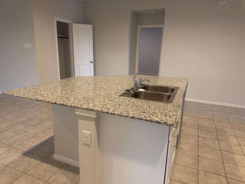 721 Durango Lane Cleburne, TX 76033 - Photo 6 of 25 a bathroom with a granite countertop sink and a mirror