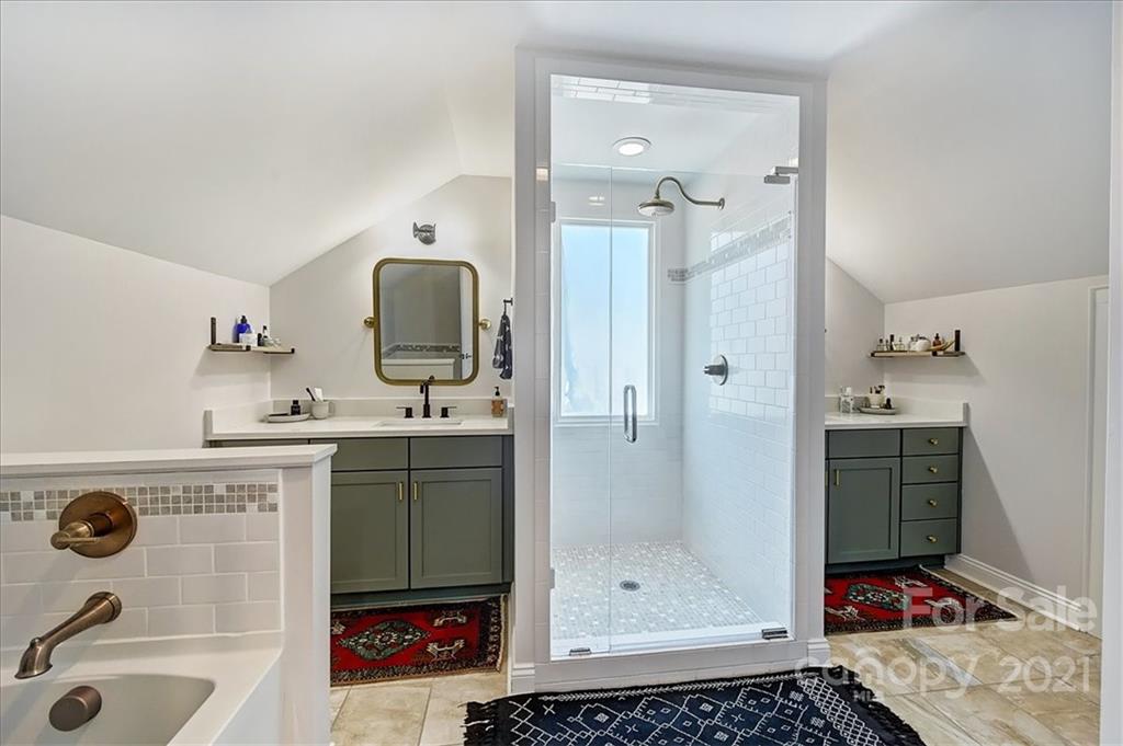 3404 Ritch Avenue Charlotte, NC 28206 - Photo 16 of 33 a bathroom with a granite countertop sink a mirror a shower and vanity