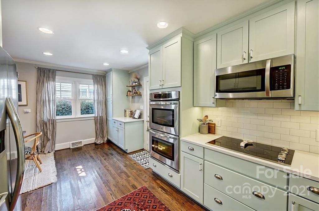 3404 Ritch Avenue Charlotte, NC 28206 - Photo 5 of 33 a kitchen with stainless steel appliances a stove a sink a microwave a refrigerator and cabinets
