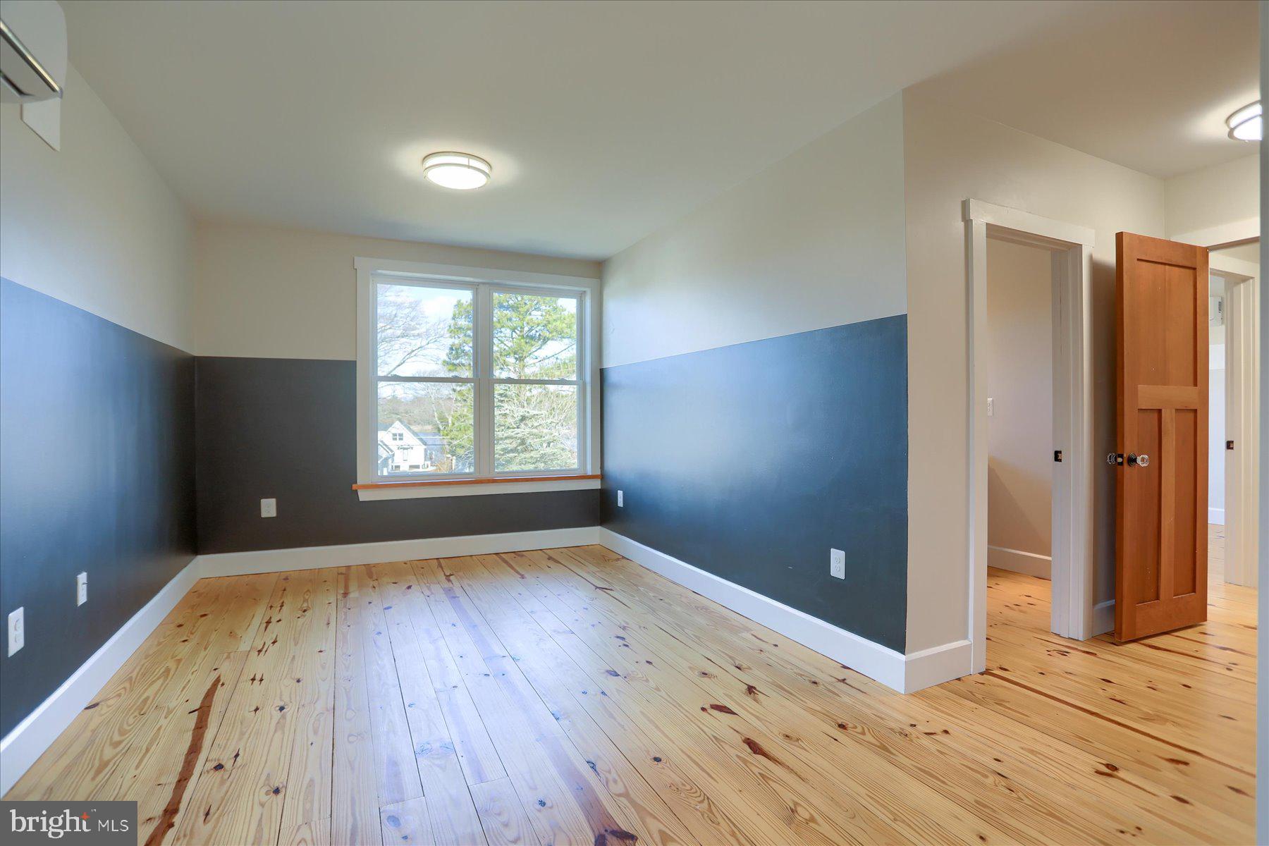 2507 Island View Road Essex, MD 21221 - Photo 19 of 51 an empty room with wooden floor and windows