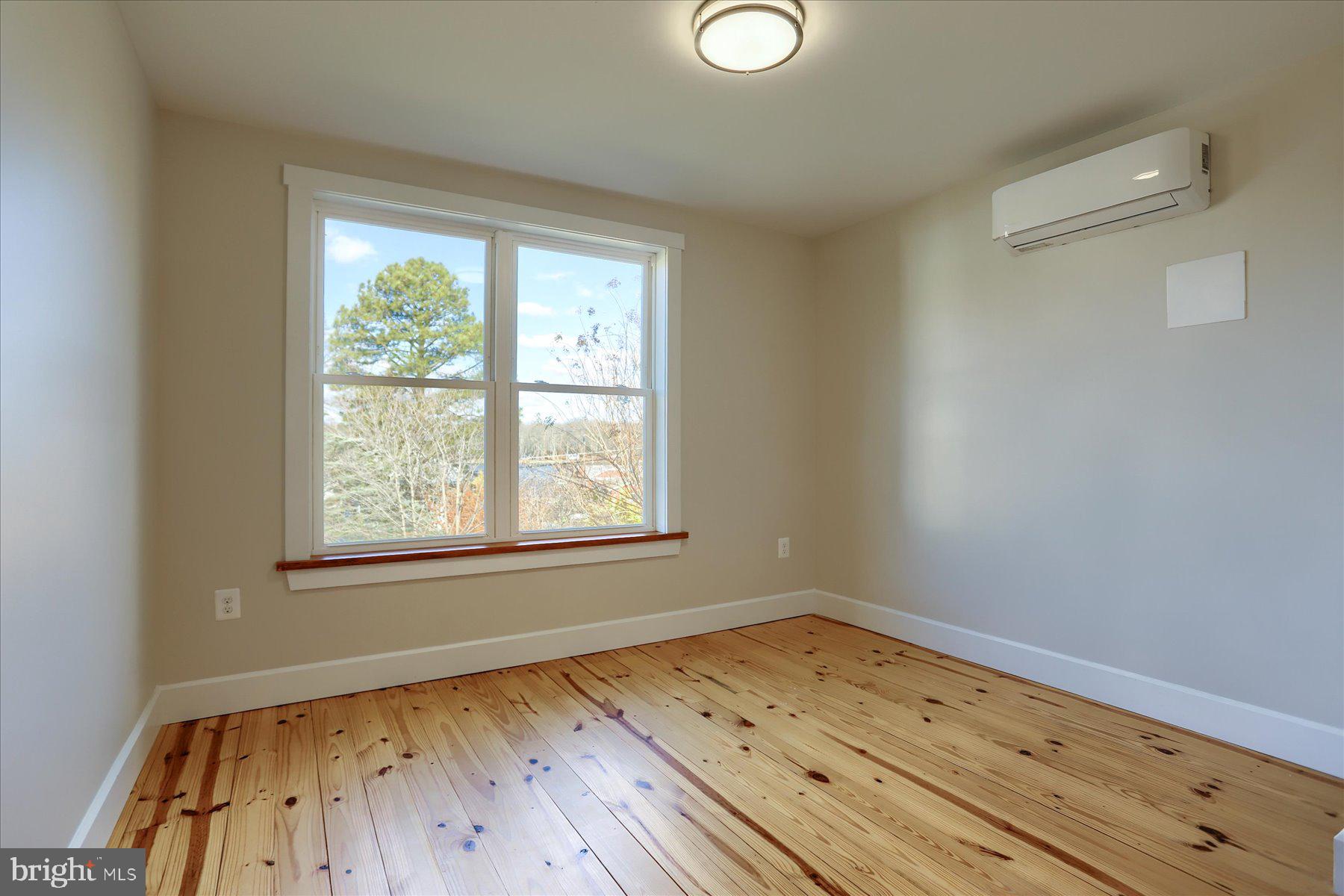 2507 Island View Road Essex, MD 21221 - Photo 23 of 51 an empty room with wooden floor and windows