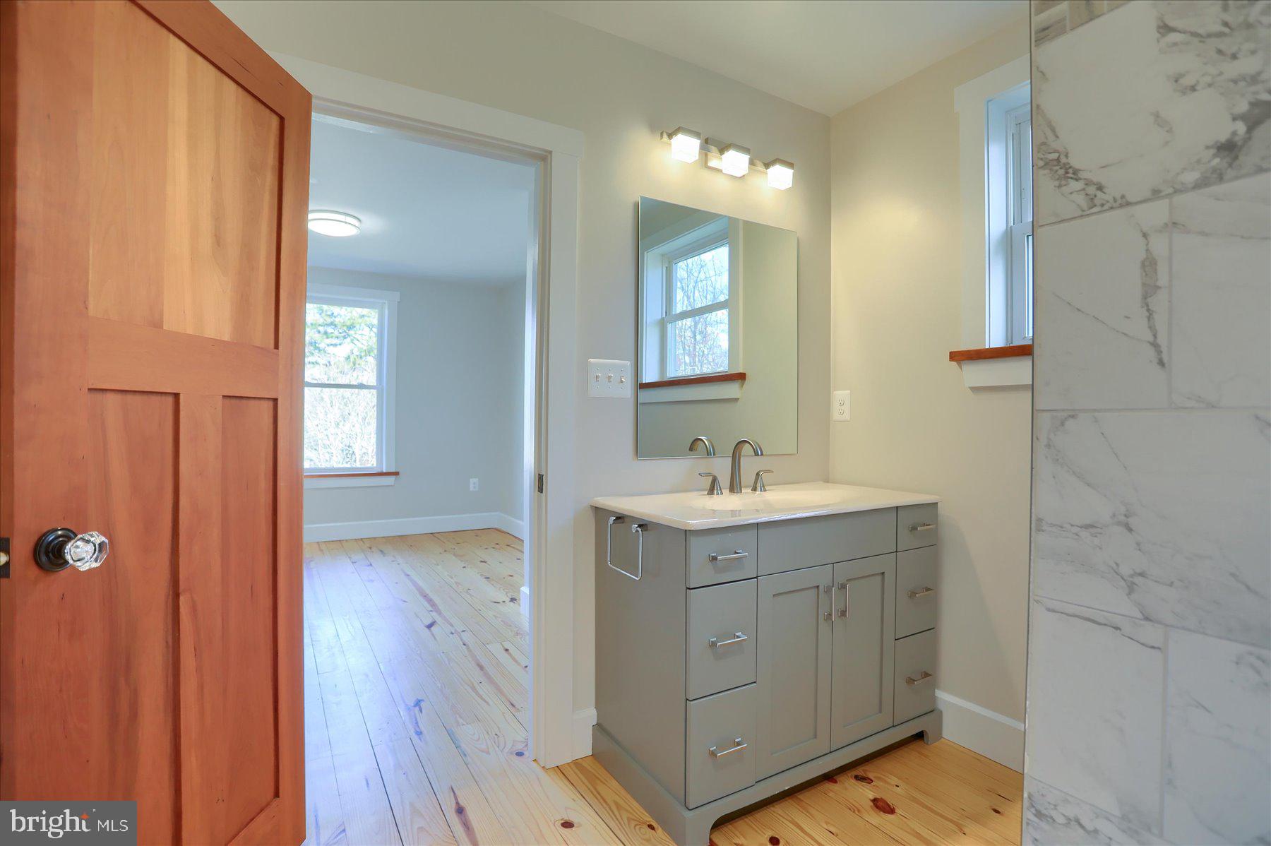 2507 Island View Road Essex, MD 21221 - Photo 24 of 51 a bathroom with a sink a light fixture and a mirror