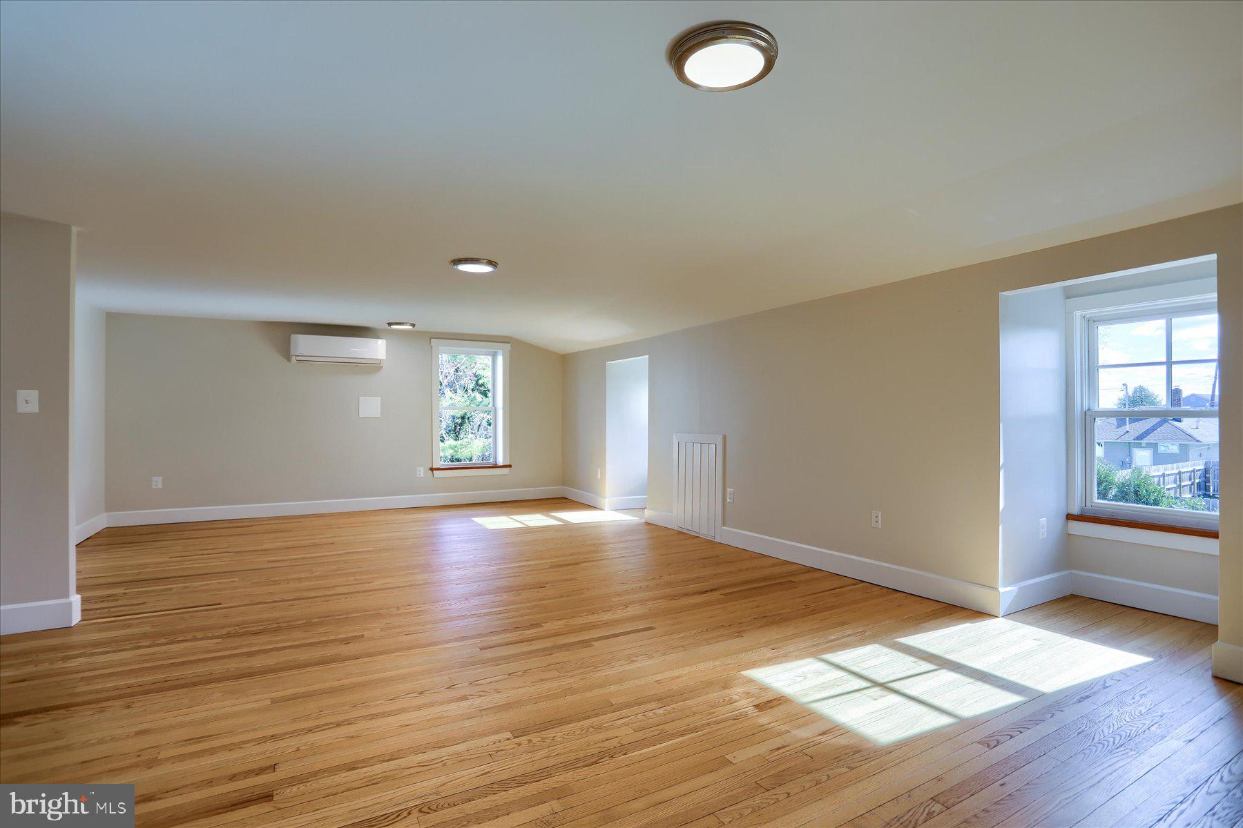 2507 Island View Road Essex, MD 21221 - Photo 31 of 51 an empty room with wooden floor and windows