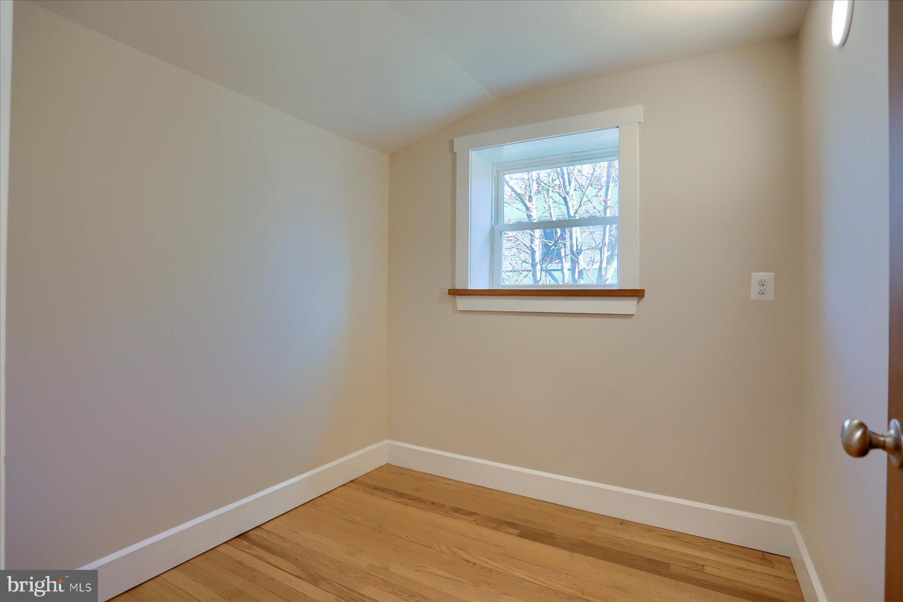 2507 Island View Road Essex, MD 21221 - Photo 33 of 51 a view of an empty room with wooden floor and a window