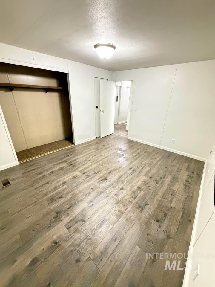 15881 Purple Sage Road, Unit 48 Caldwell, ID 83607 - Photo 13 of 17 Unfurnished bedroom with hardwood / wood-style flooring and a closet