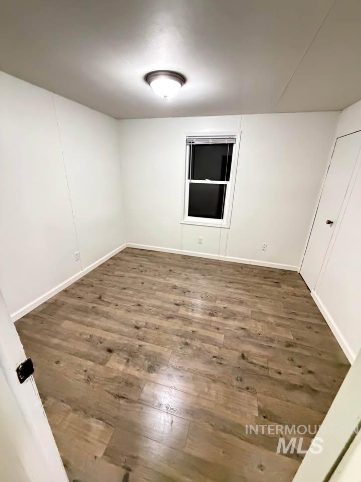 15881 Purple Sage Road, Unit 48 Caldwell, ID 83607 - Photo 14 of 17 Empty room with dark wood-style floors