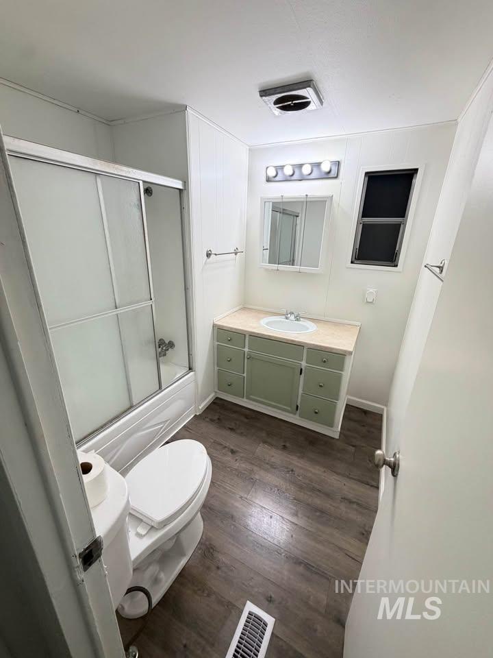 15881 Purple Sage Road, Unit 48 Caldwell, ID 83607 - Photo 5 of 17 Full bathroom featuring vanity, dark wood finished floors, and shower / bath combination with glass door