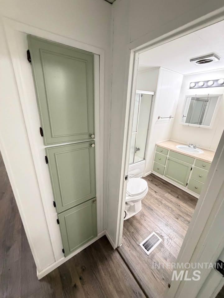 15881 Purple Sage Road, Unit 48 Caldwell, ID 83607 - Photo 8 of 17 Full bathroom featuring dark wood finished floors, vanity, and combined bath / shower with glass door
