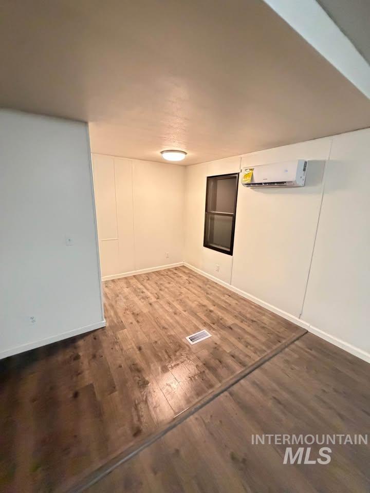 15881 Purple Sage Road, Unit 48 Caldwell, ID 83607 - Photo 10 of 17 Finished below grade area featuring dark wood finished floors and a wall mounted mini split