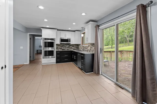 a bathroom with a granite countertop sink a toilet and a shower