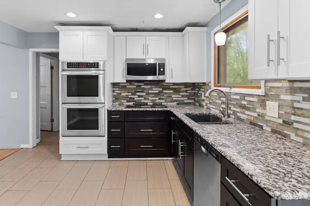 a white bath tub sitting next to a white cabinet