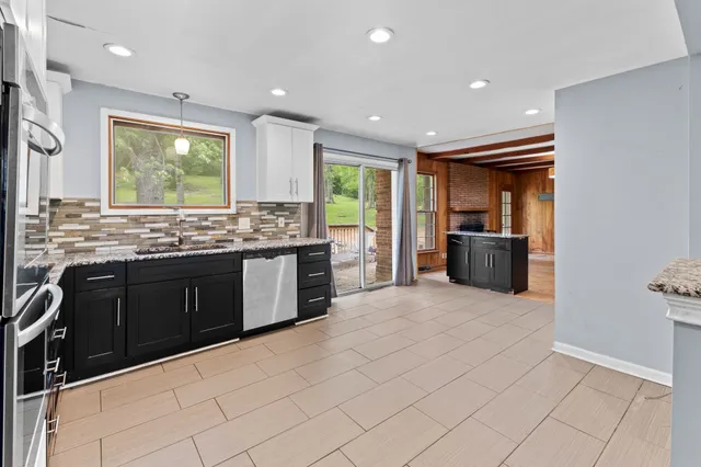 a view of a livingroom with wooden floor and a ceiling fan