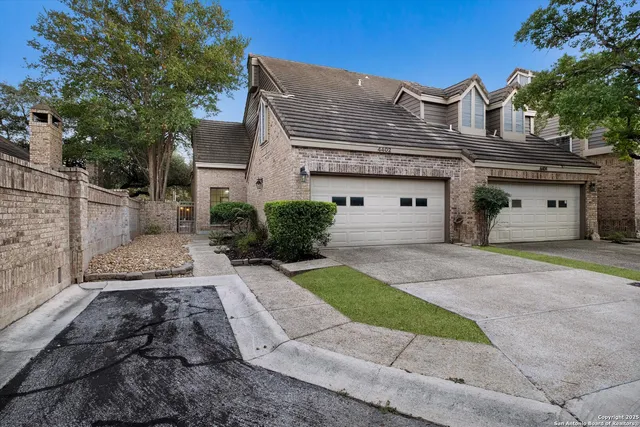 a front view of a house with a yard and a garage