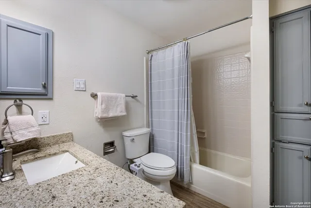 a bathroom with a sink toilet and shower