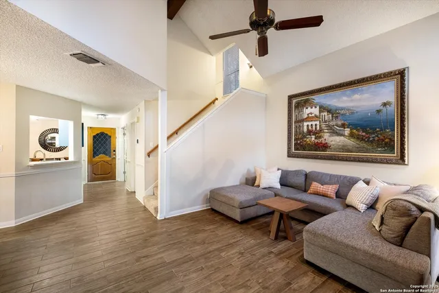a living room with furniture and wooden floor