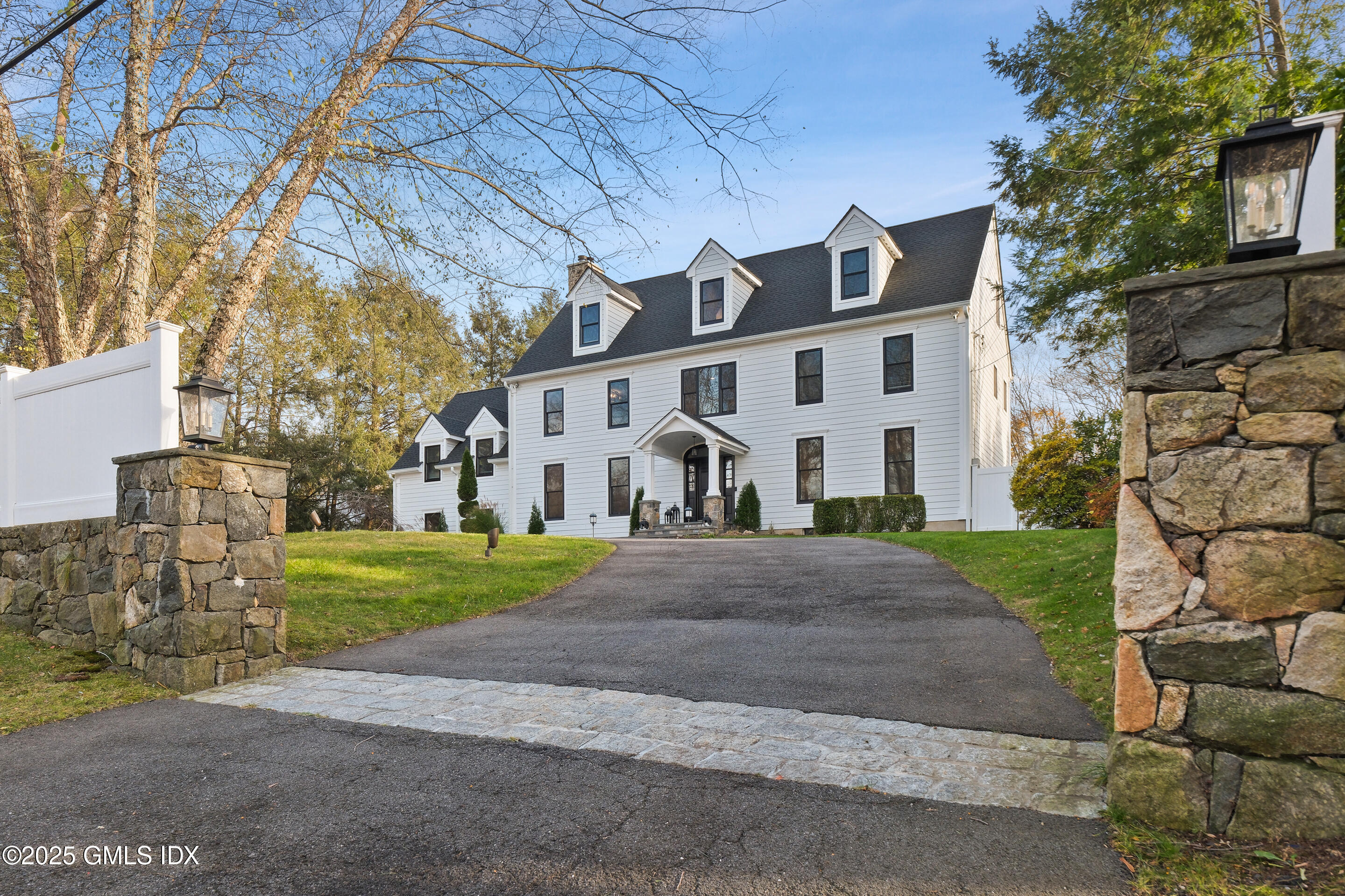 4 Banksville Avenue Greenwich, CT 06831 - Photo 1 of 37 a front view of a house with a yard and garage