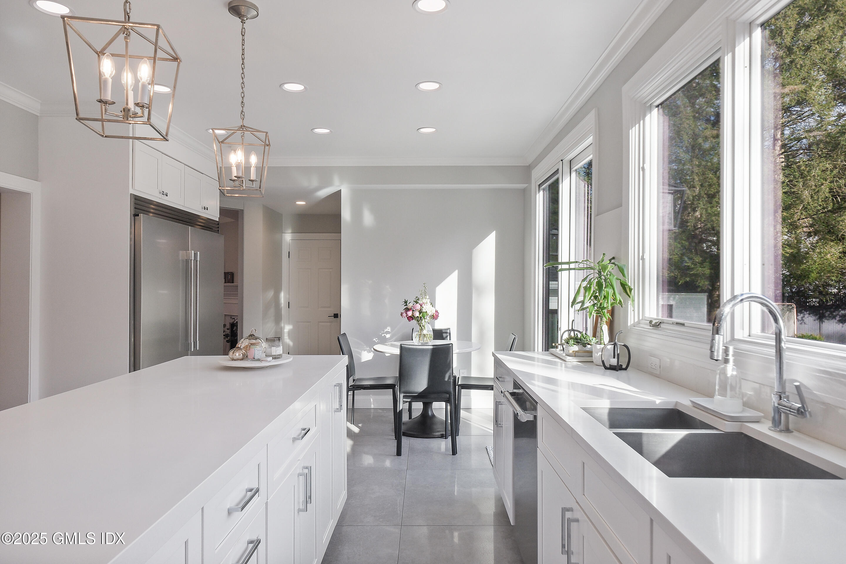 4 Banksville Avenue Greenwich, CT 06831 - Photo 11 of 37 a large kitchen with kitchen island a large counter space a sink a center island stainless steel appliances and windows