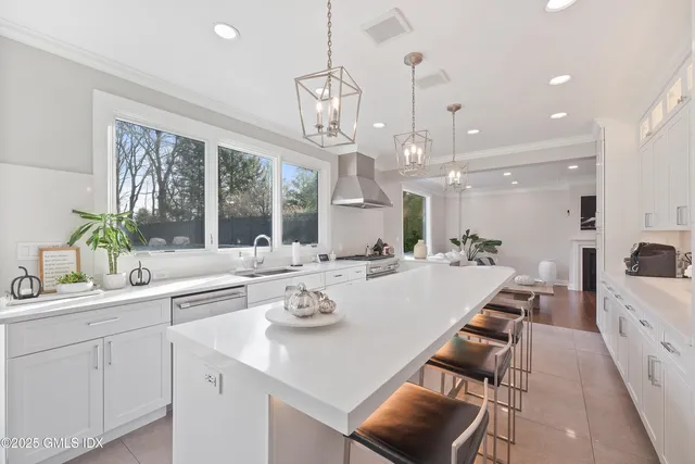 a large kitchen with a table and chairs