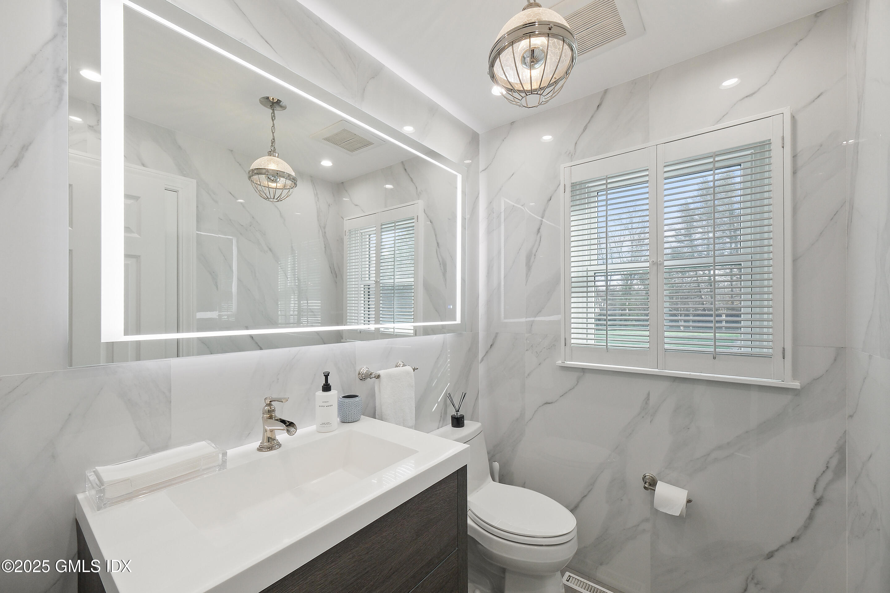 4 Banksville Avenue Greenwich, CT 06831 - Photo 17 of 37 a bathroom with a sink a toilet and a mirror