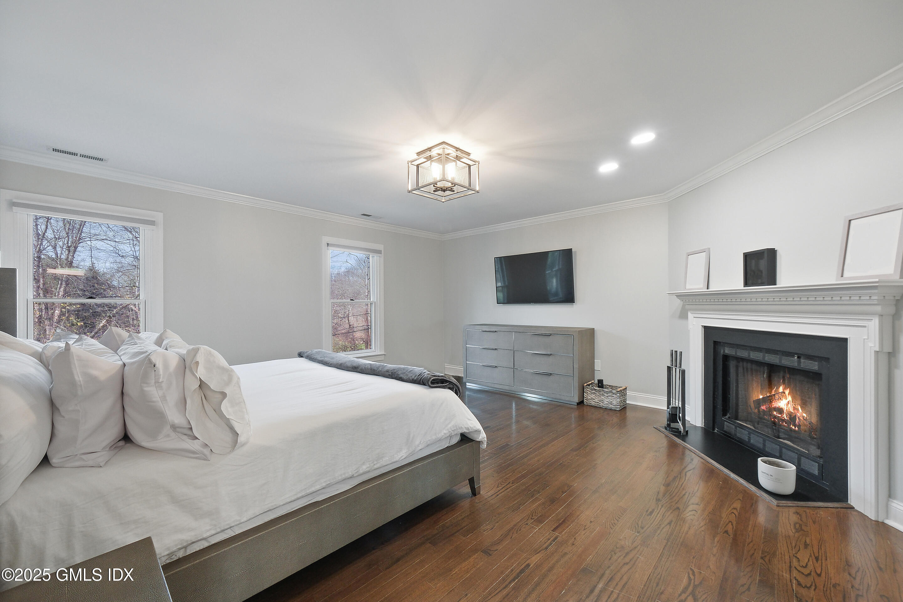 4 Banksville Avenue Greenwich, CT 06831 - Photo 20 of 37 a bedroom with a bed and a fireplace