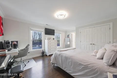 a bedroom with a bed and a desk