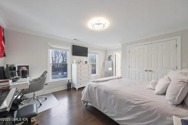 a bedroom with a bed and a desk