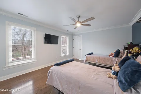 a bedroom with a large bed and a window