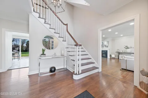 a view of entryway and hall with wooden floor
