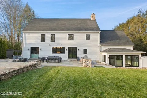 a front view of a house with patio and garden