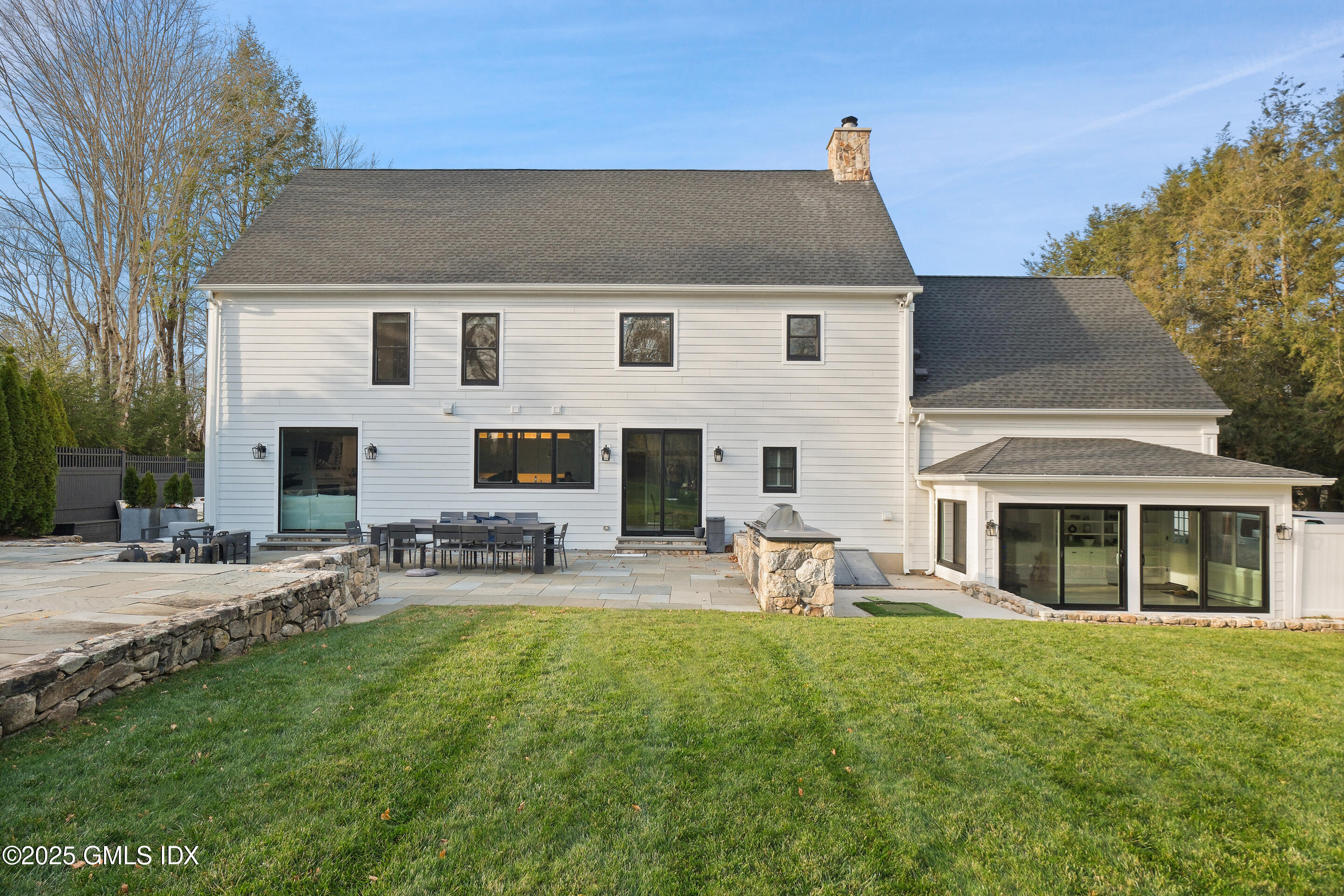 4 Banksville Avenue Greenwich, CT 06831 - Photo 31 of 37 a front view of a house with patio and garden