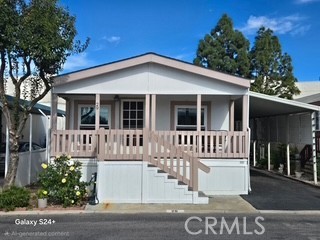 195 Tierra Rejada Road, Unit 29 Simi Valley, CA 93065 - Photo 1 of 33 a view of a white house with large windows and a small yard