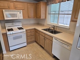 195 Tierra Rejada Road, Unit 29 Simi Valley, CA 93065 - Photo 16 of 33 a kitchen with white cabinets and white appliances