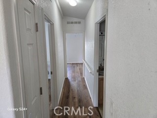 195 Tierra Rejada Road, Unit 29 Simi Valley, CA 93065 - Photo 25 of 33 a view of a hallway with wooden floor and stairs