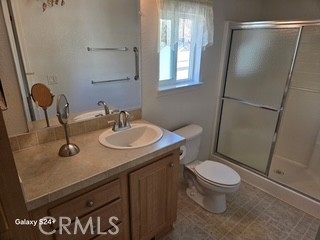 195 Tierra Rejada Road, Unit 29 Simi Valley, CA 93065 - Photo 32 of 33 a bathroom with a granite countertop sink toilet and shower