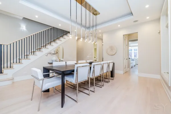 a view of a dining room with furniture and a chandelier