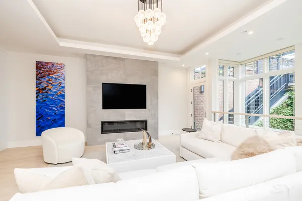 a living room with furniture a flat screen tv and a fireplace