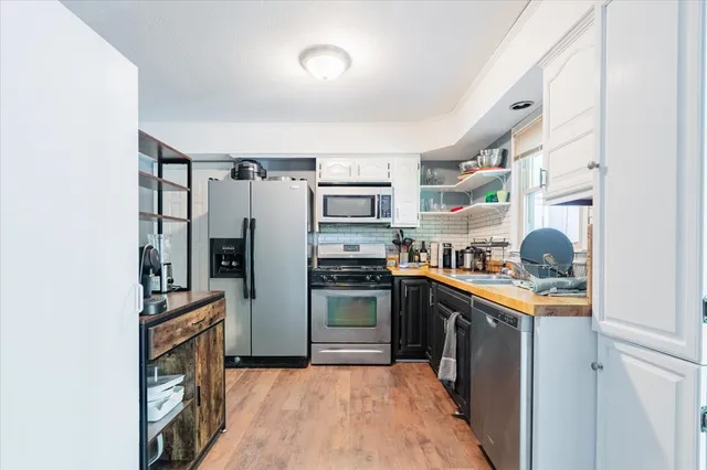 a kitchen with stainless steel appliances granite countertop a stove top oven
