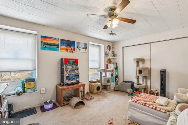 a bedroom with furniture and a chandelier fan