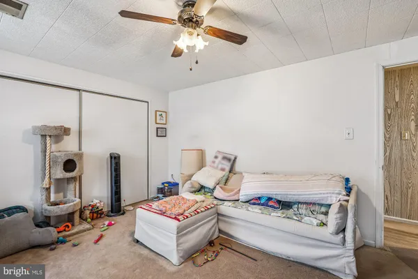 a living room with furniture and a book shelf
