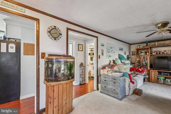 a kitchen with stainless steel appliances kitchen island granite countertop a sink a stove a dining table and chairs