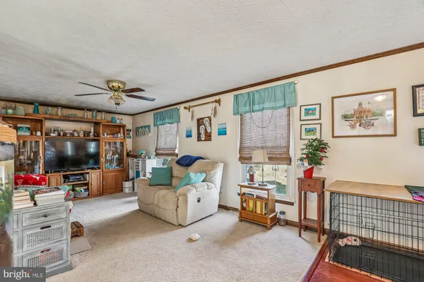 a kitchen with a stove a refrigerator a sink and chairs