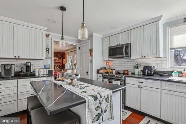a kitchen with a sink stove and microwave