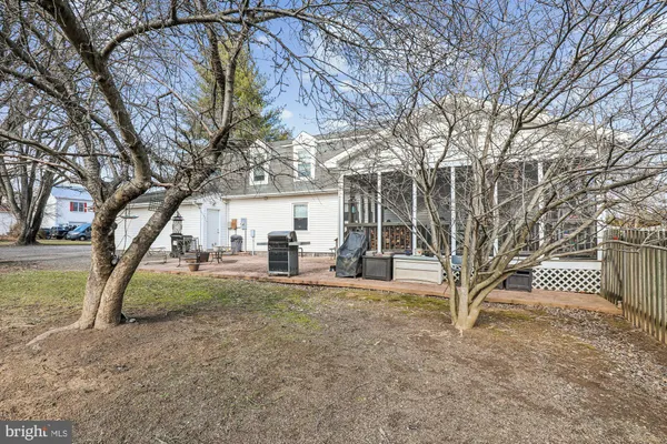a view of backyard with wooden fence