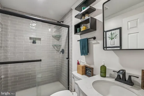 a bathroom with a sink toilet and shower