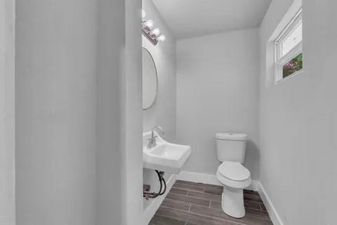 110 North Hillside Street Red Oak, TX 75154 - Photo 18 of 25 Half bathroom with toilet and wood finish floors