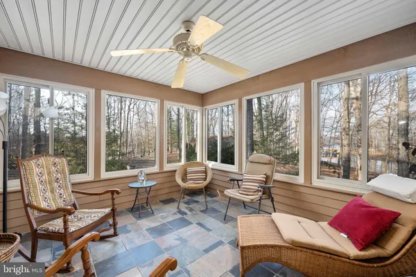 a bedroom with furniture window and a ceiling fan