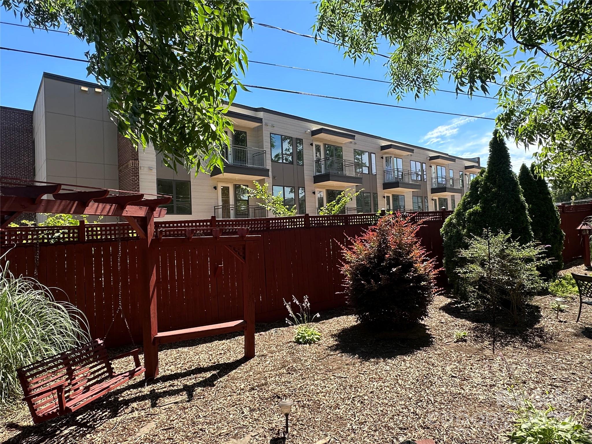 400 Bowman Road, Unit 1 Charlotte, NC 28217 - Photo 8 of 16 a view of a patio with table and chairs potted plants and large tree