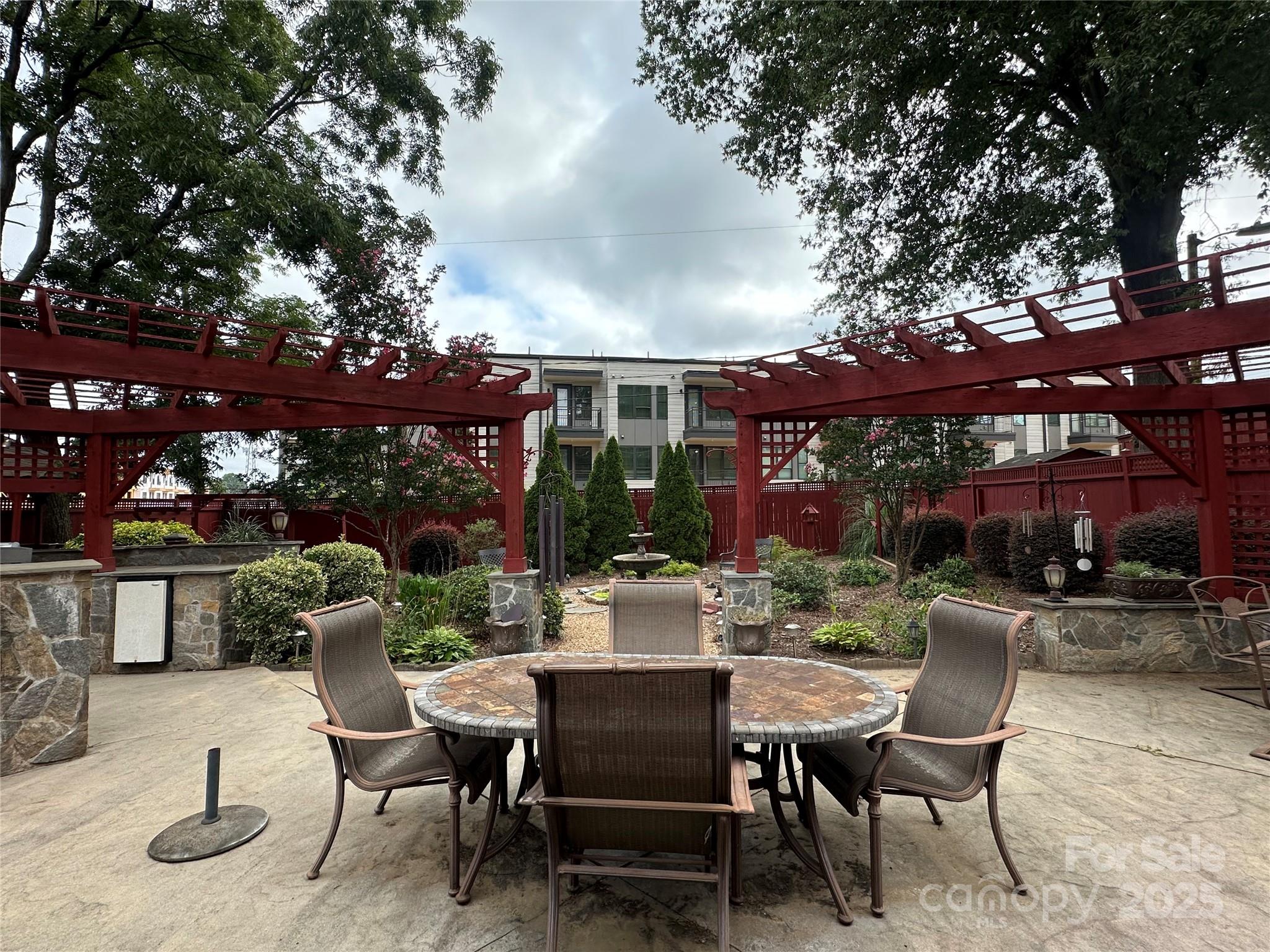 400 Bowman Road, Unit 1 Charlotte, NC 28217 - Photo 9 of 16 a patio with a table and chairs and potted plants