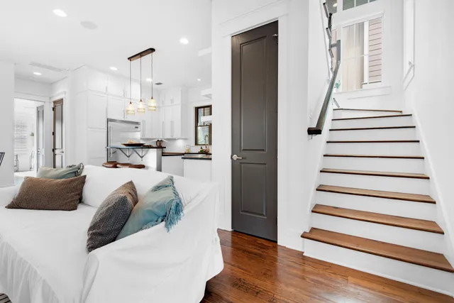a living room with furniture and a wooden floor